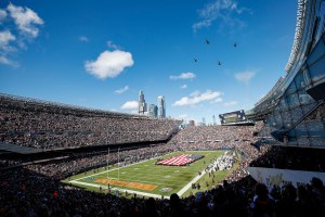An aerial shot of the inside of Soldier Field, with planes flying overhead