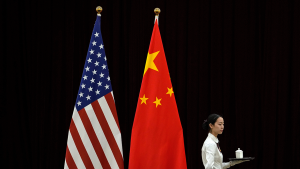 A hostess walks by American and Chinese flags ahead of the bilateral meeting between US Treasury Secretary Janet Yellen and Chinese Vice Premier He Lifeng on April 6, 2024.